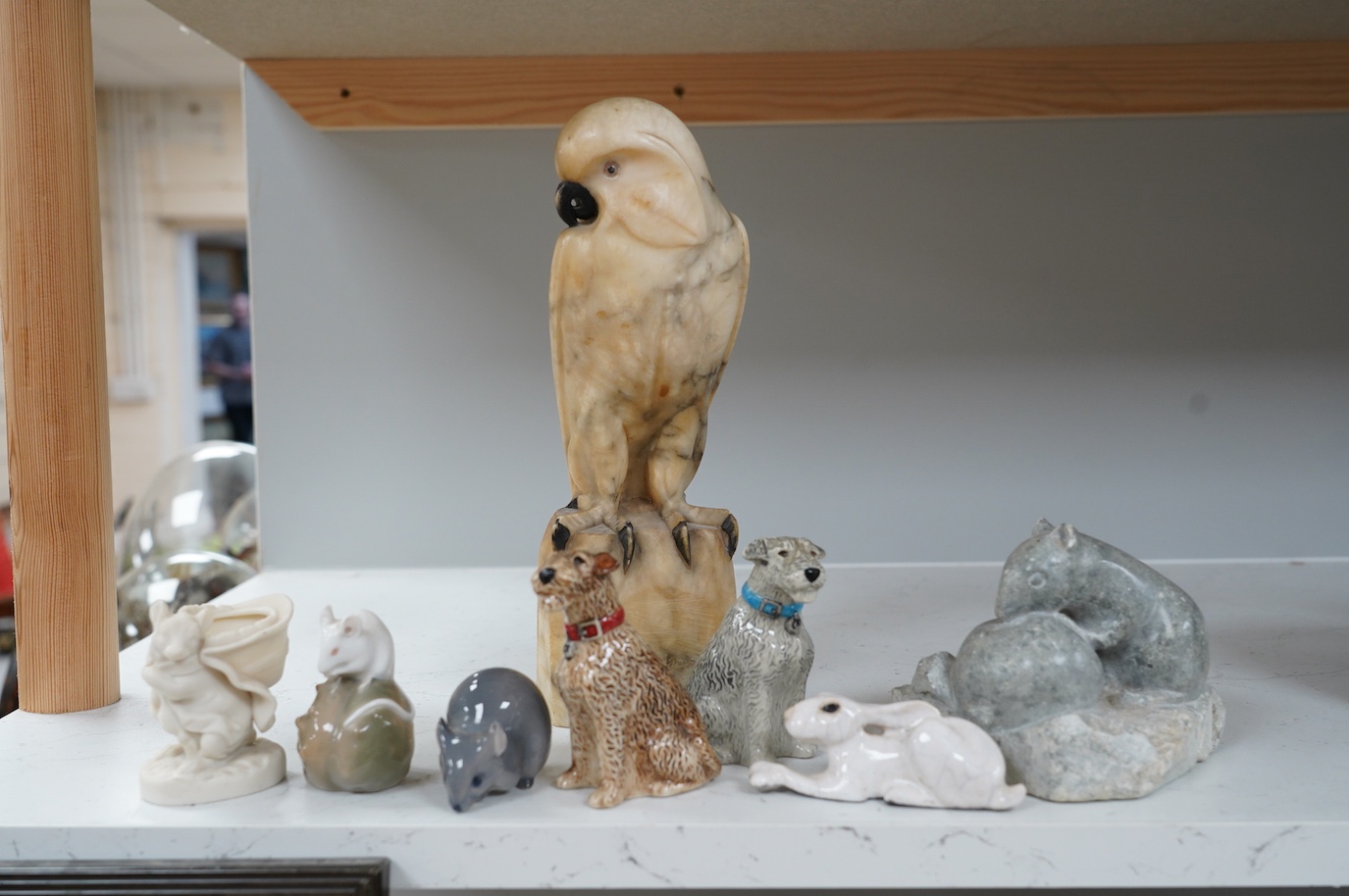 A carved alabaster parrot, a stone carving of two mice, two Royal Copenhagen mice, a mouse spill vase, a pair of dog pepperettes and a hare ornament, tallest 26cm high (8). Condition - small chip to ear of white Copenhag